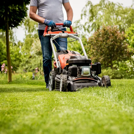 Lawn pro mowing a customer's yard